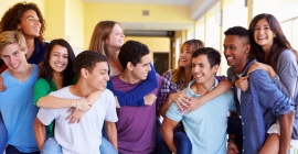 A group of teenagers smiling at eachother